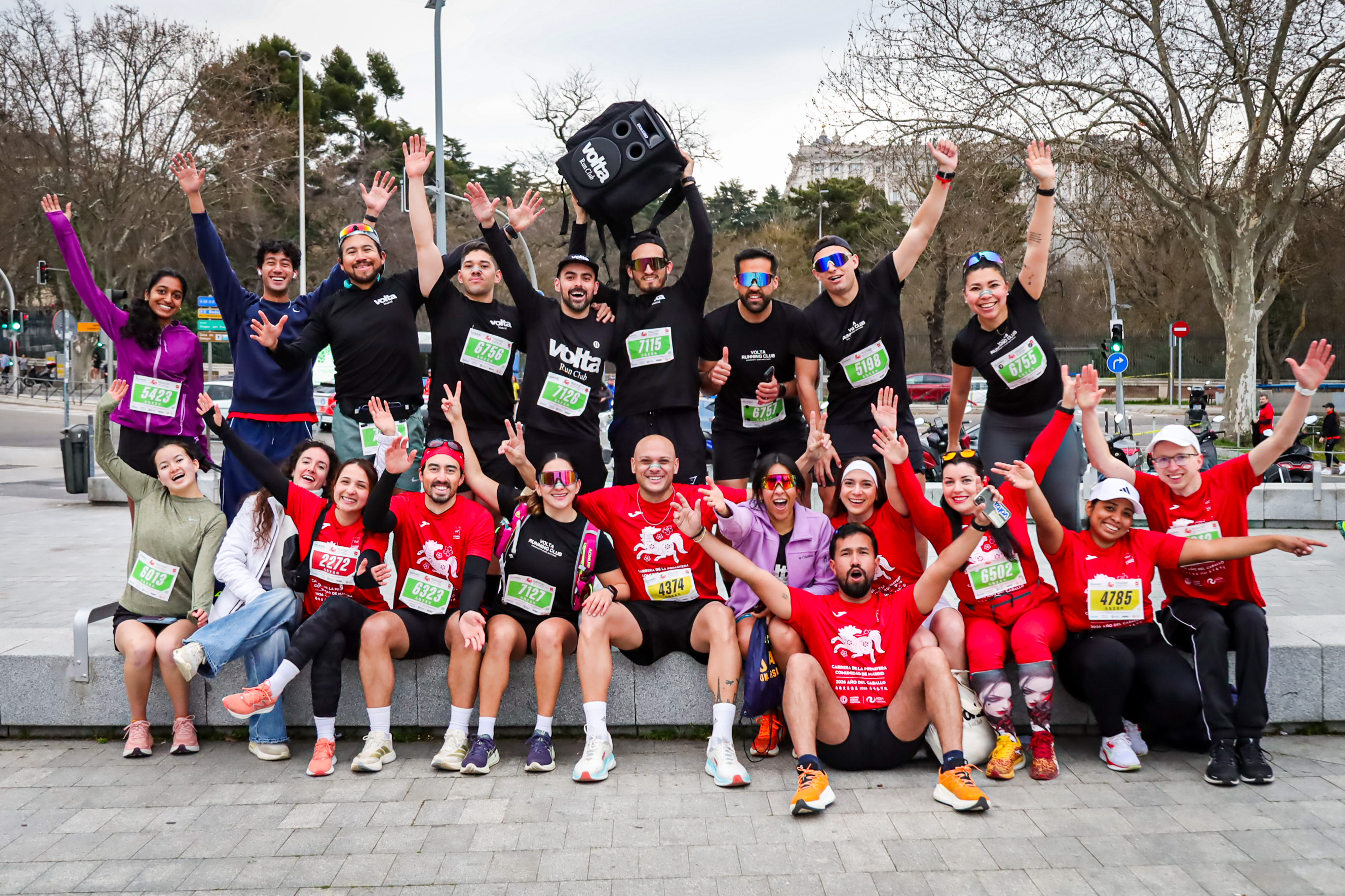 A running club team celebrating together after finishing the Carrera de la Primavera