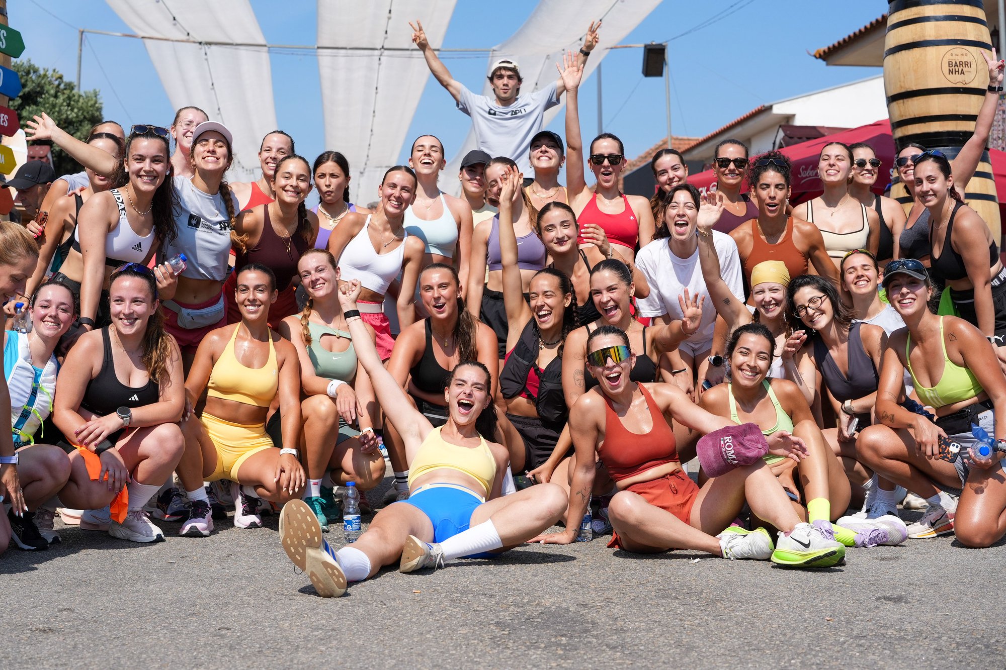 A large group of runners celebrate together in Esmoriz's Barrinha area after the 25Km Pela Vida road race