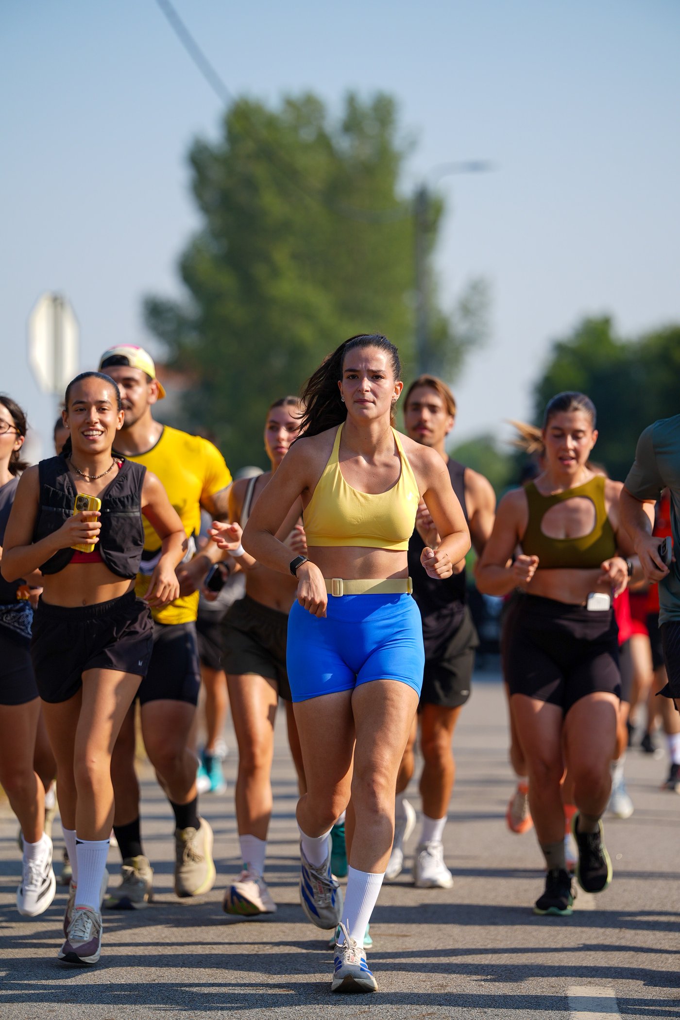 A runner in a yellow top leads a pack of competitors along the 25Km Pela Vida course in Esmoriz