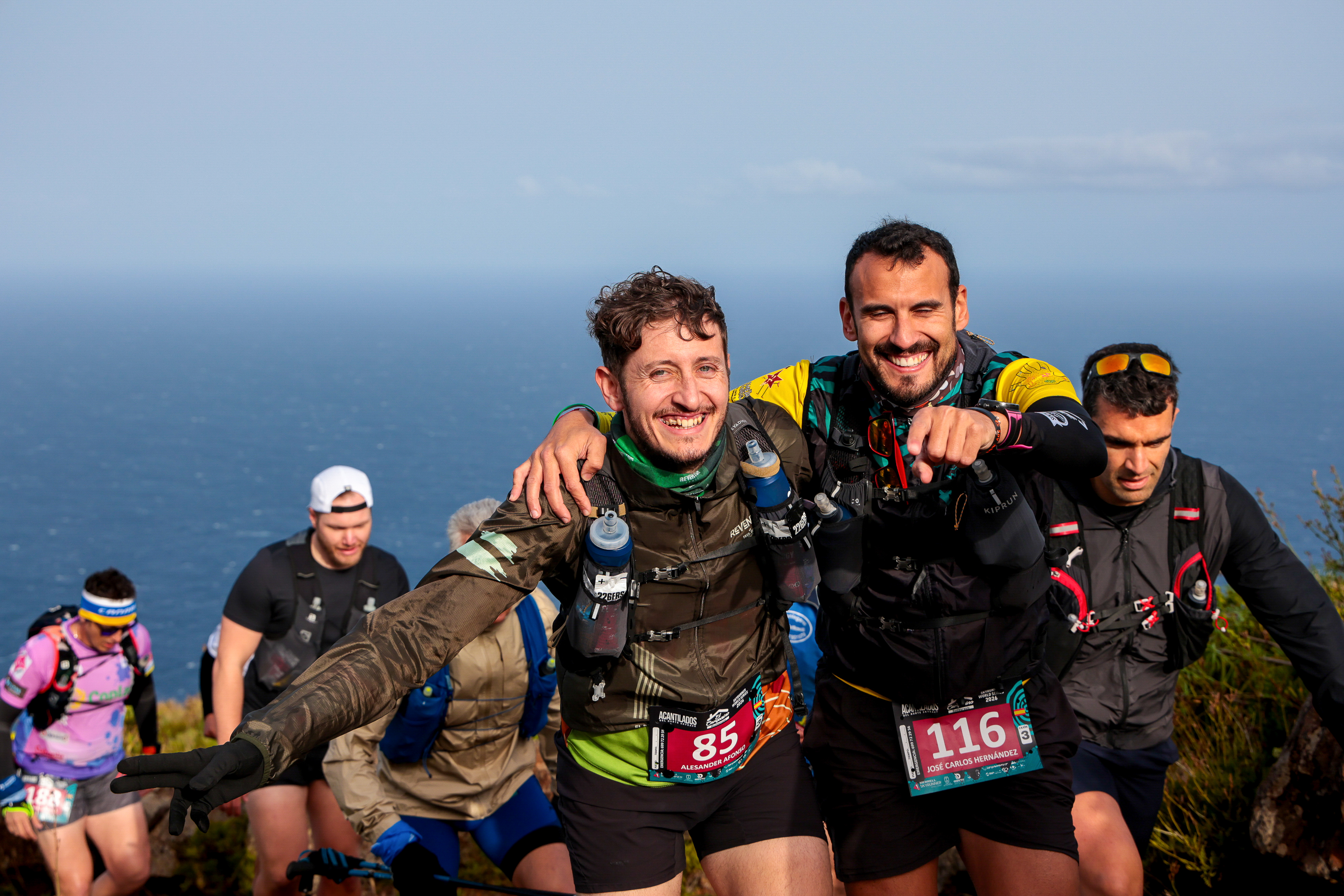 Runners embracing on the Acantilados del Norte Skyrace coastal trail