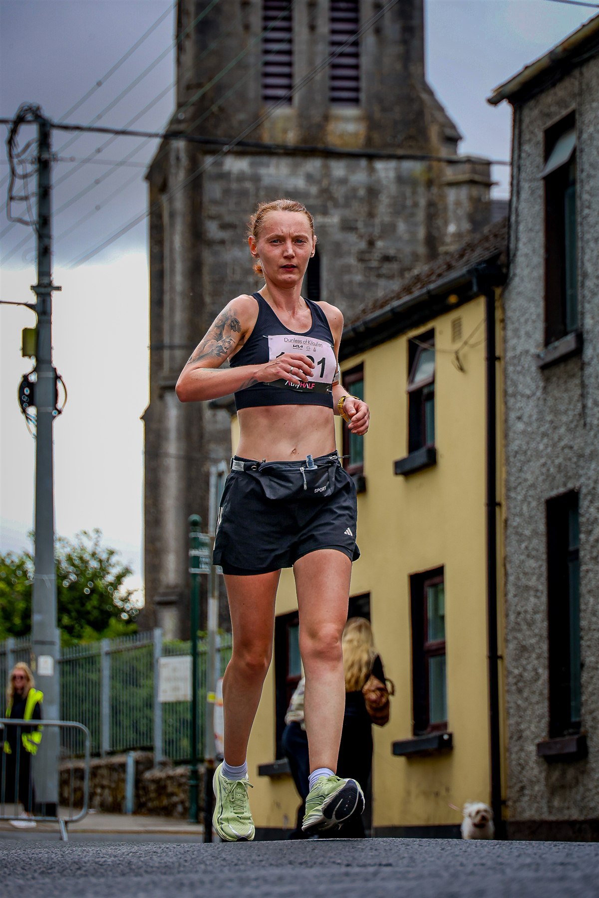 A female runner competes on the streets of Athy during the 2026 Athy Half Marathon programme