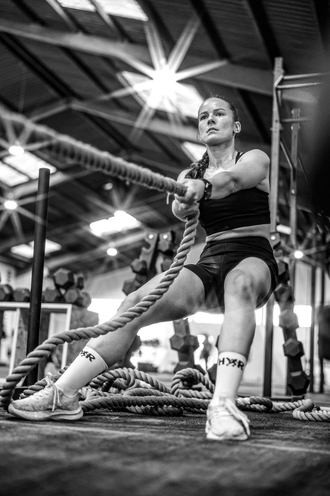 A competitor pulls a weighted sled by rope during the III Avynt Hyrox Simulation in Vila Nova de Gaia