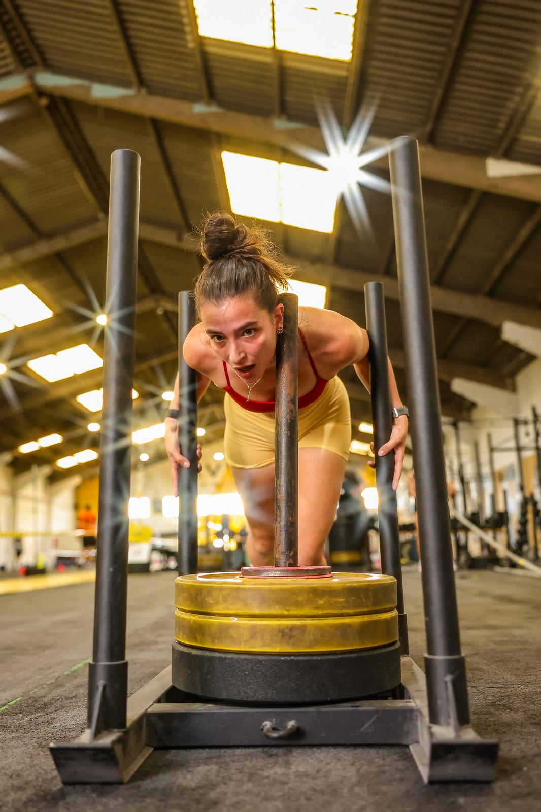 A competitor pushes a weighted sled through a rig at the III Avynt Hyrox Simulation in Vila Nova de Gaia