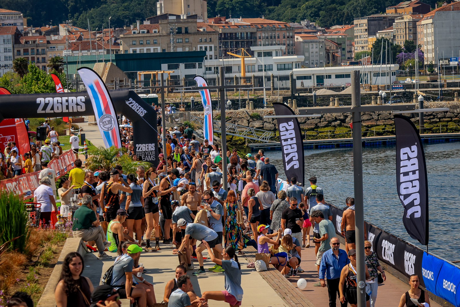 Runners and spectators gather along the waterfront finish area at the V Carmiña Carreira in Marín