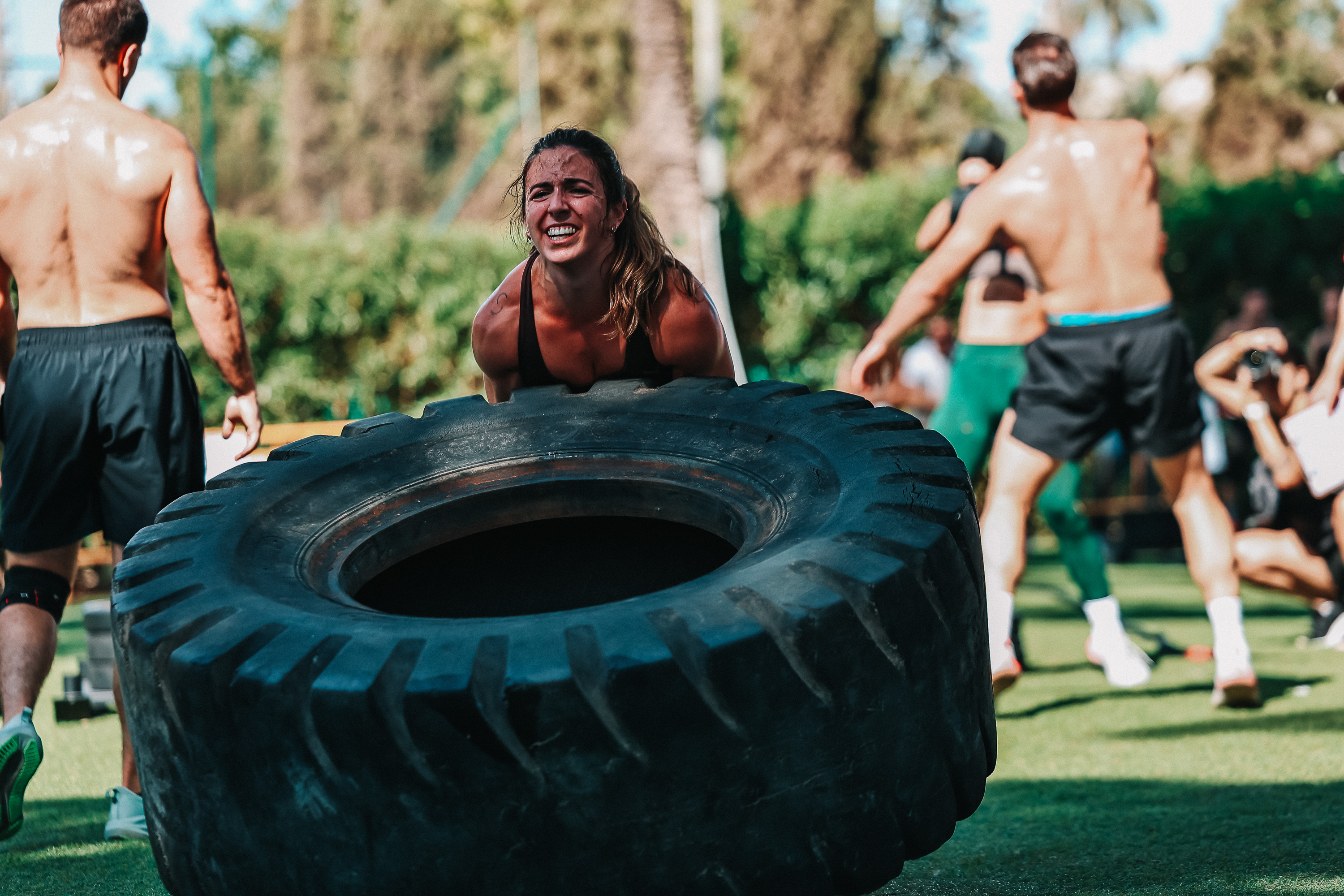 An athlete strains through a tyre flip during the Costa Blanca Games in Alicante