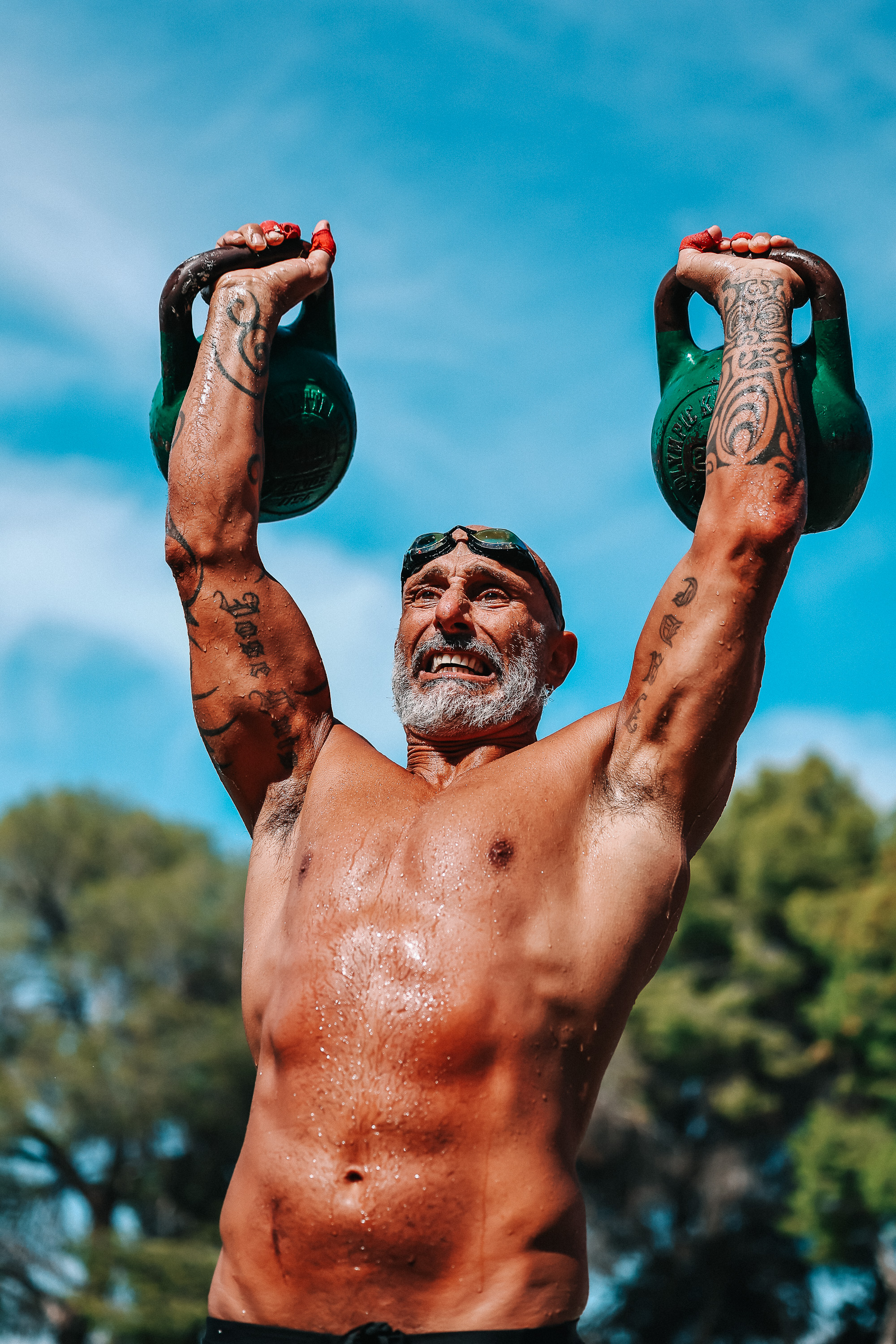 An athlete raises two kettlebells overhead during the Costa Blanca Games
