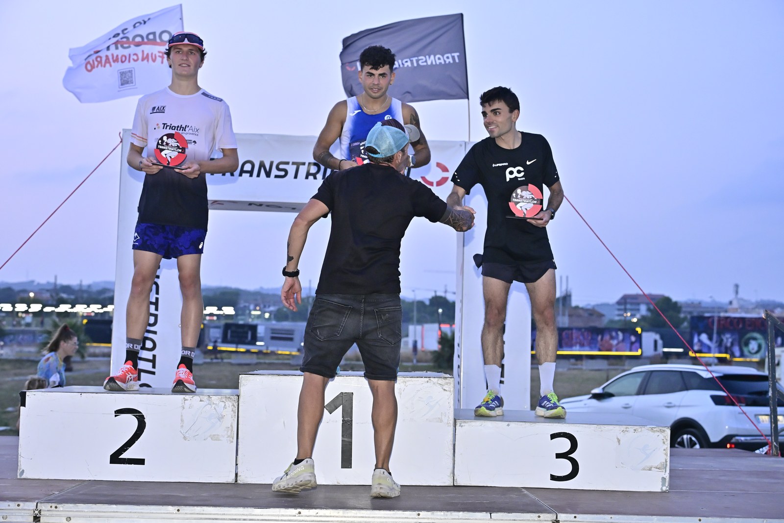 The men's top three stand on the podium during the awards ceremony at the inaugural Cunit Night Race