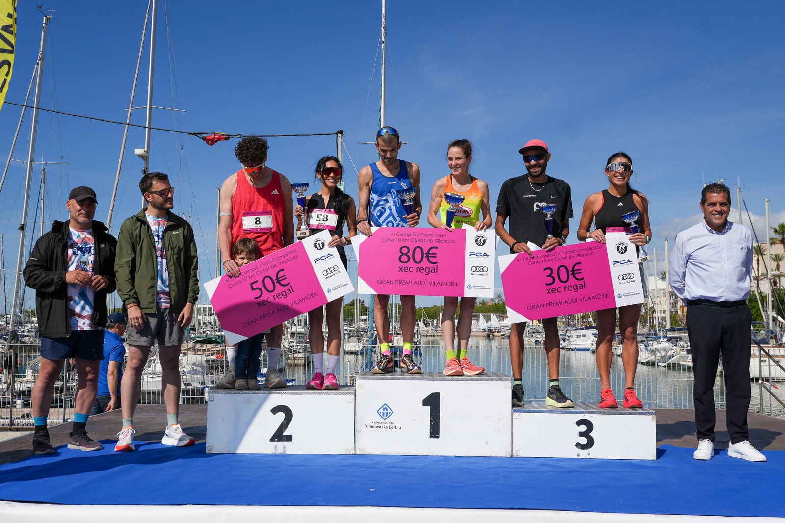 Runners on the awards podium at the Cursa Ciutat de Vilanova prize ceremony