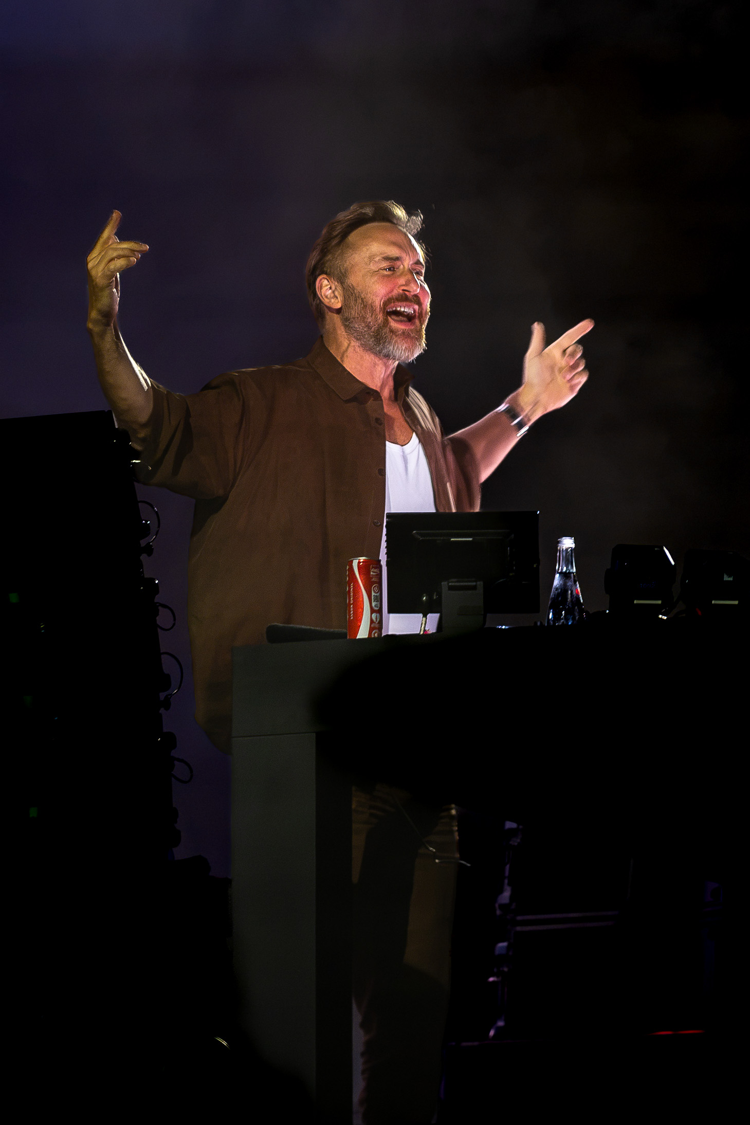 David Guetta gestures to the crowd from behind the DJ booth during The Monolith Tour in Loures