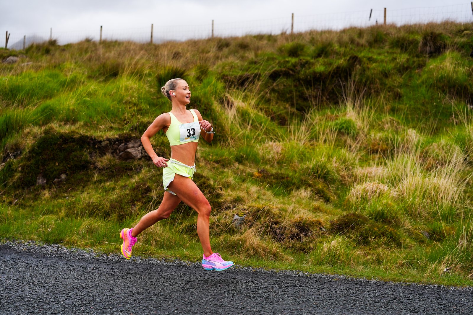 A runner in bright yellow racing kit on the Delphi Half Marathon course
