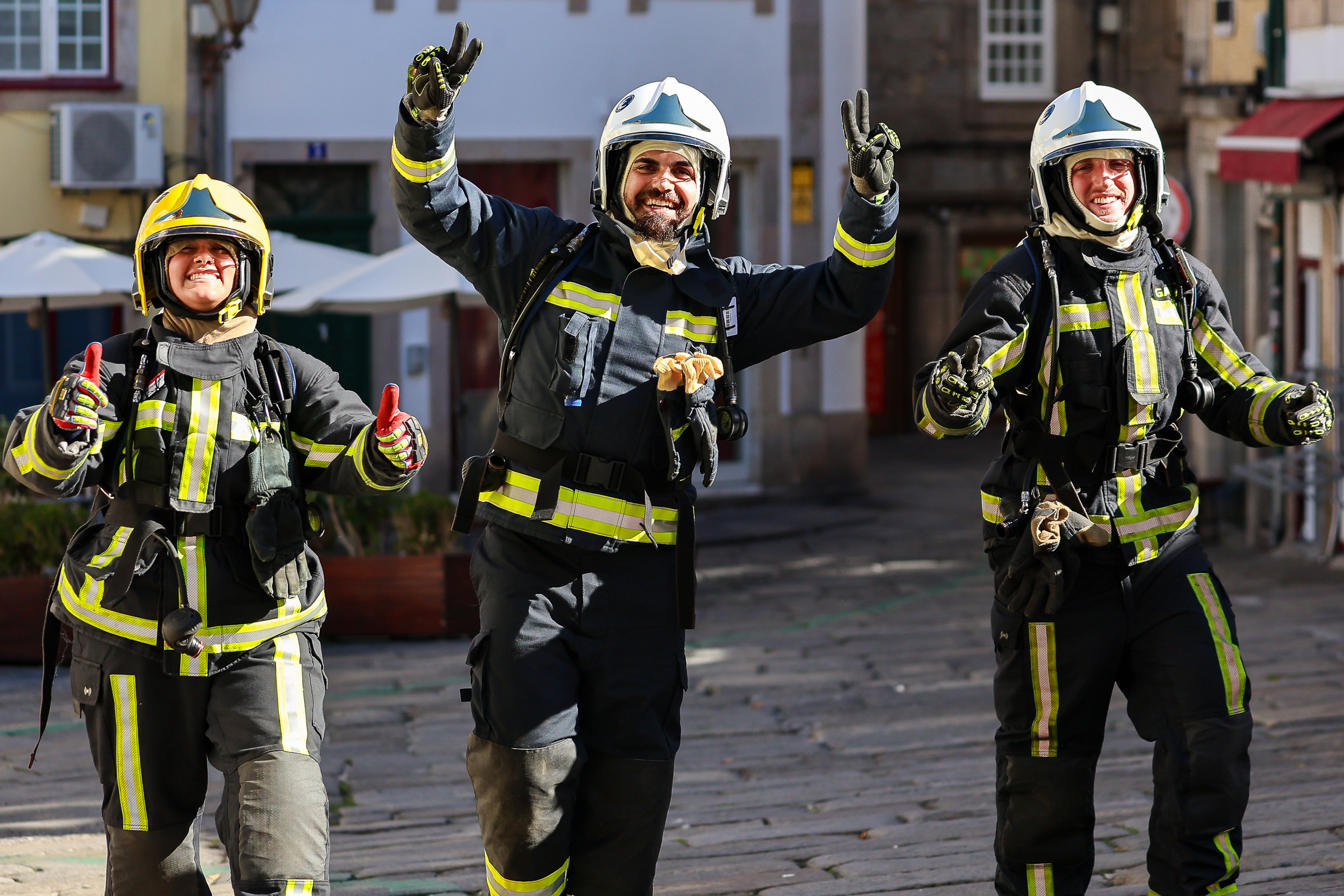 Three firefighters celebrate after the Firestorm Challenge in Viseu