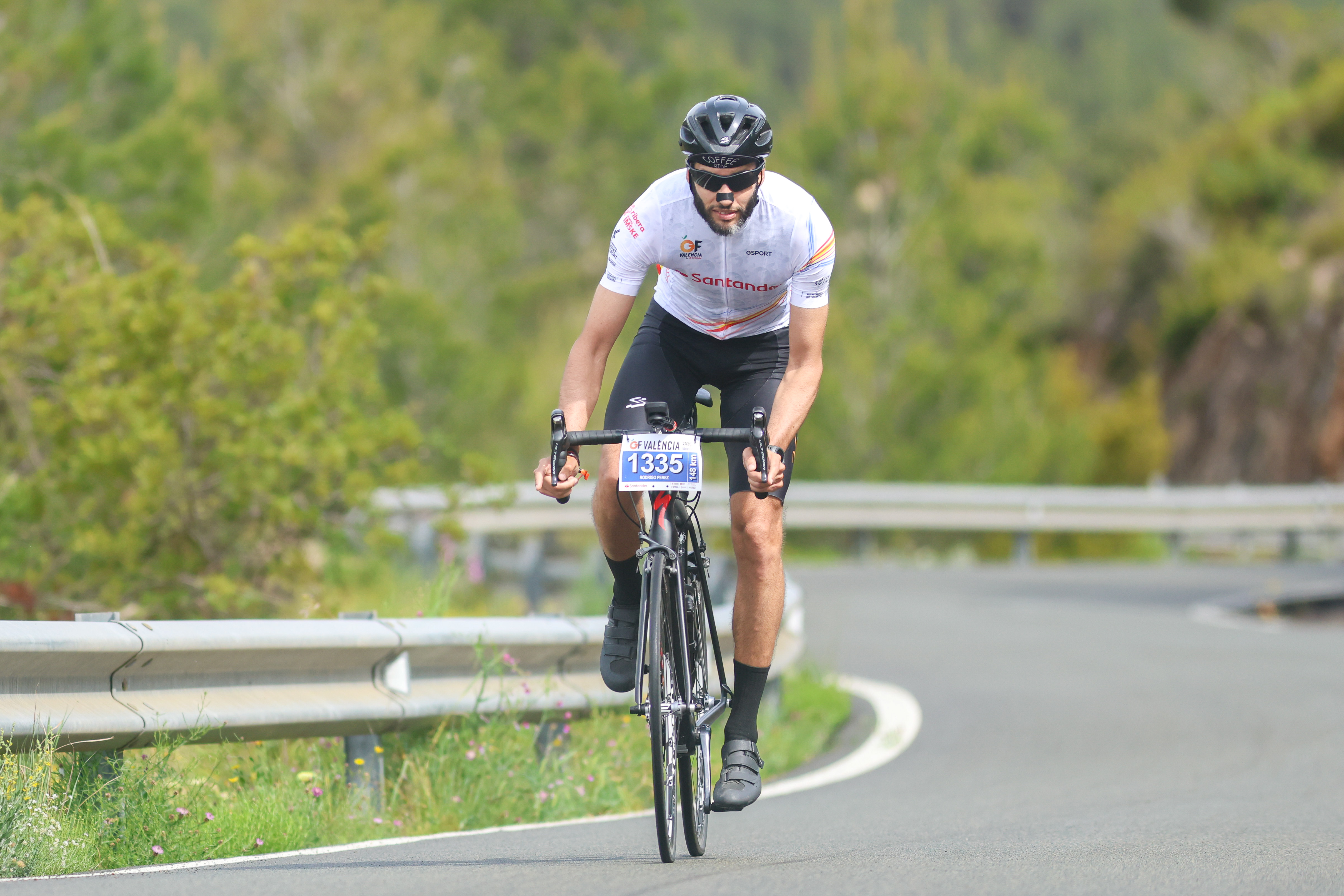 A cyclist riding solo on a mountain road at Gran Fondo València