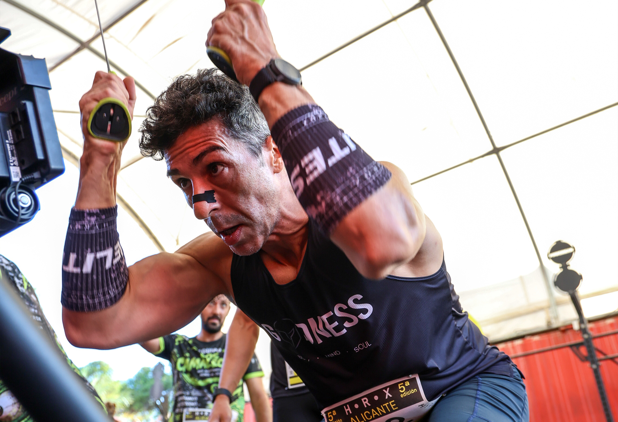 An athlete pulls the handles of a ski ergometer at HRX Alicante