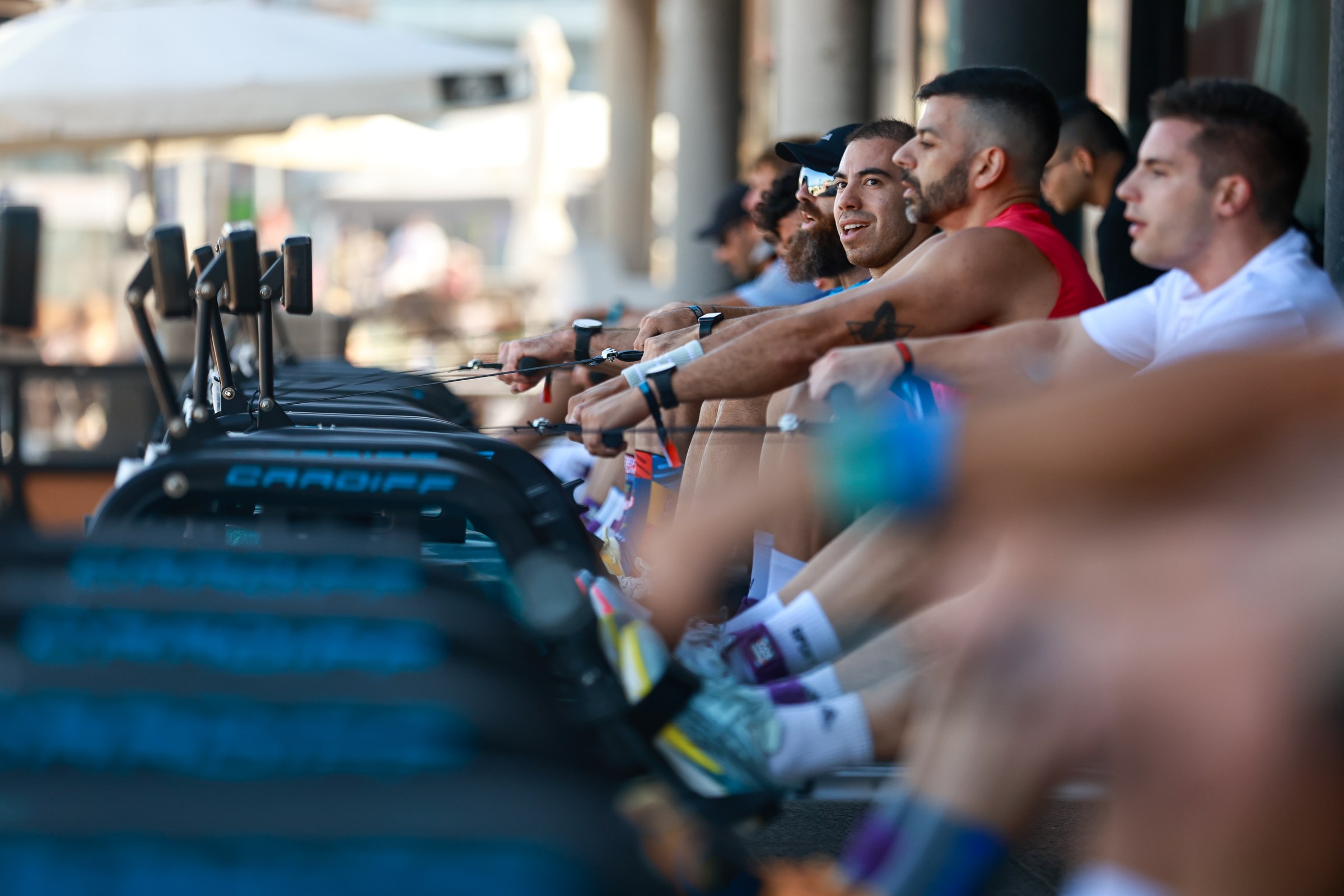 Athletes work side by side on rowing machines during HURBAX Gijón