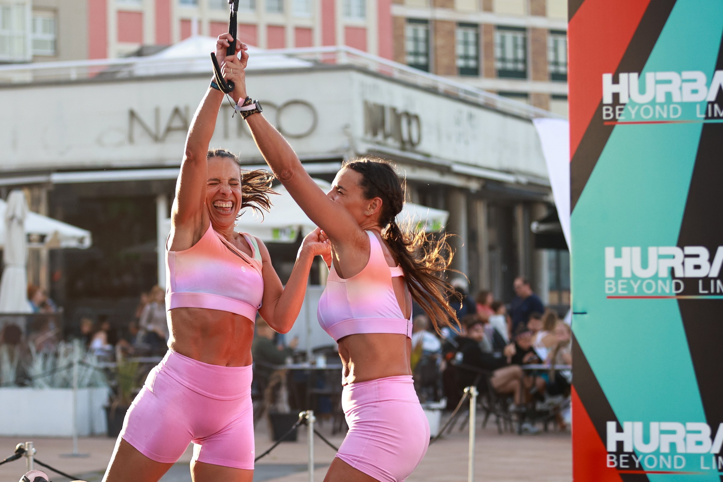 Two women celebrate together during HURBAX Gijón