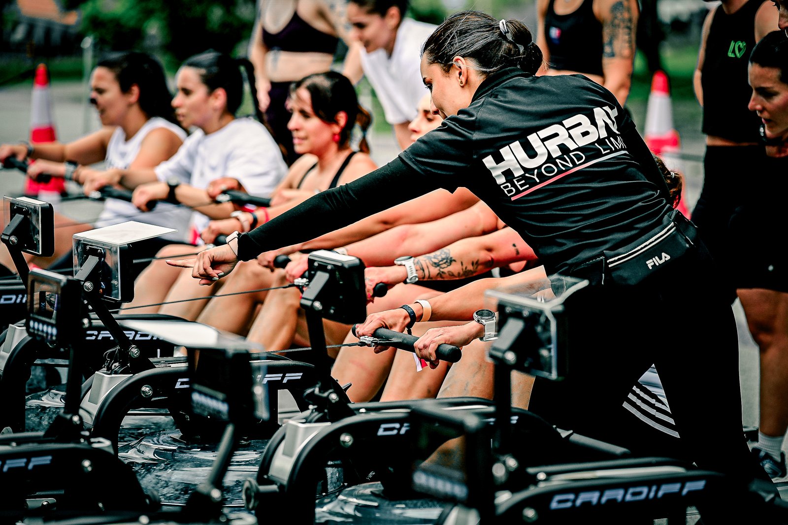 A Hurbax coach directing athletes on rowing machines during Hurbax Pontevedra