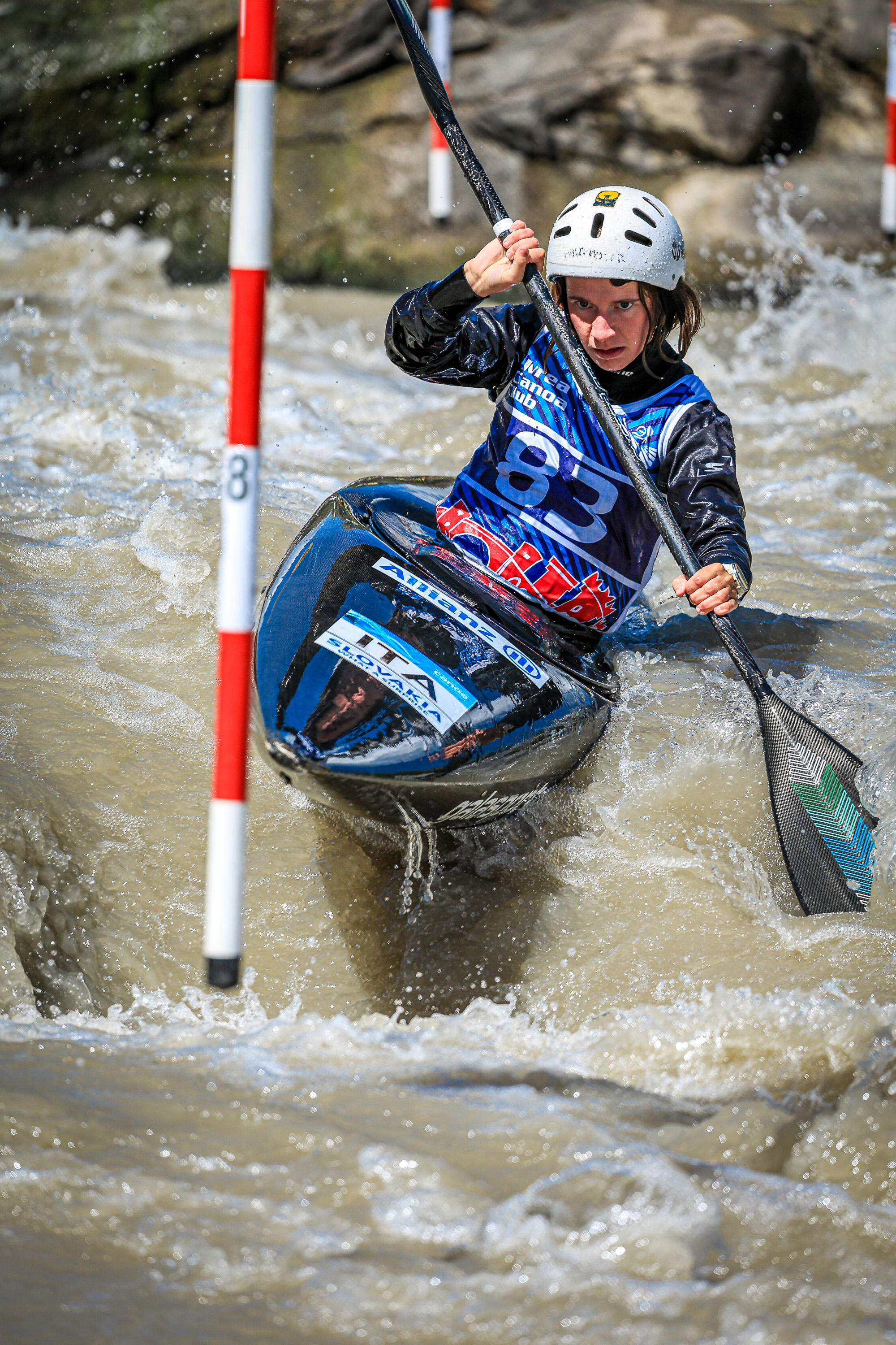 A women's K1 competitor navigates a slalom gate at the Italian Championships in Ivrea