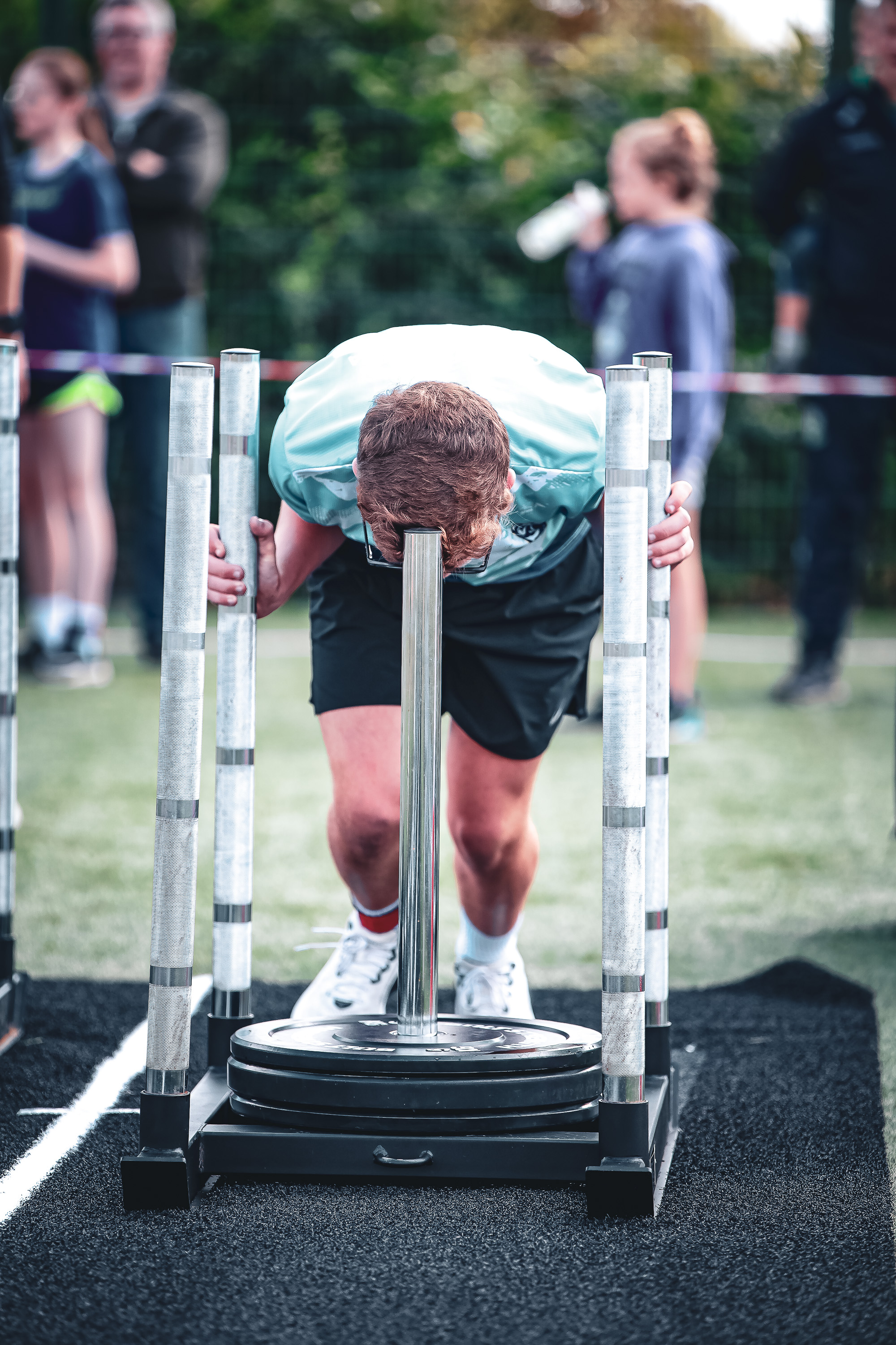 A young KIDSROX athlete drives a weighted sled between marker poles in Dublin