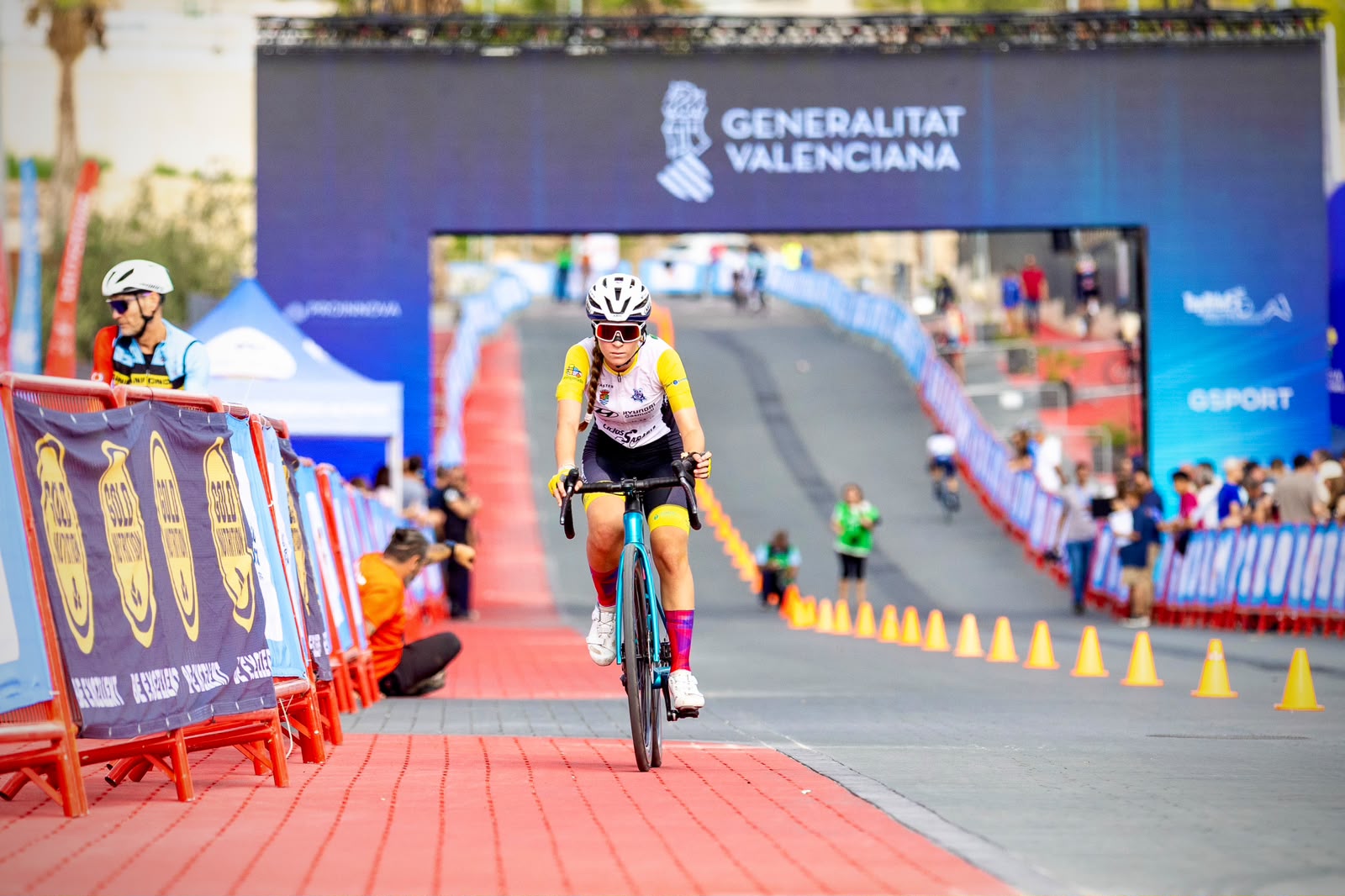 A young cyclist returns along the finish straight in La Nucía