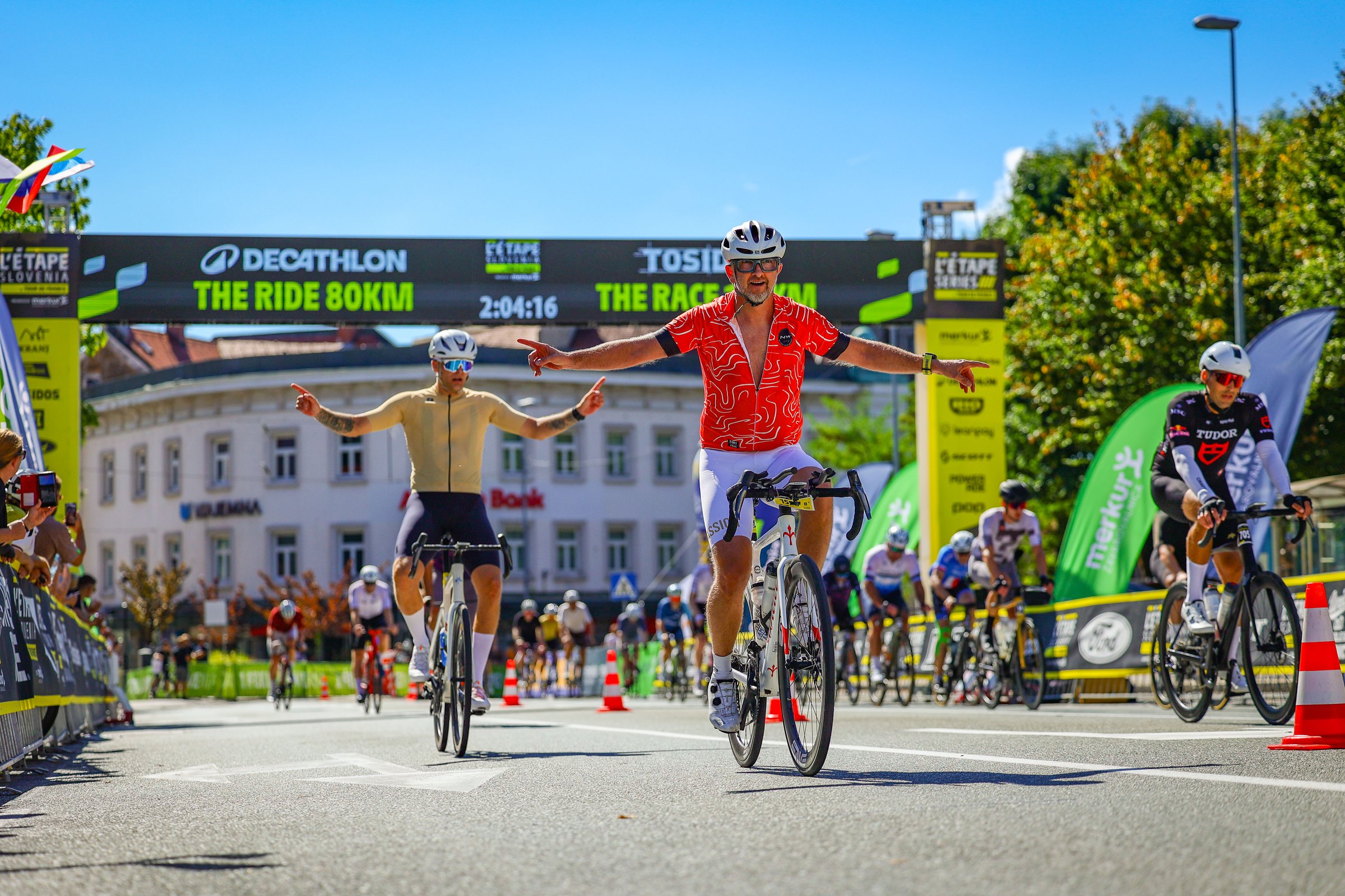 Cyclists celebrate as they cross the finish line at L’Étape Slovenia 2026 in Kranj