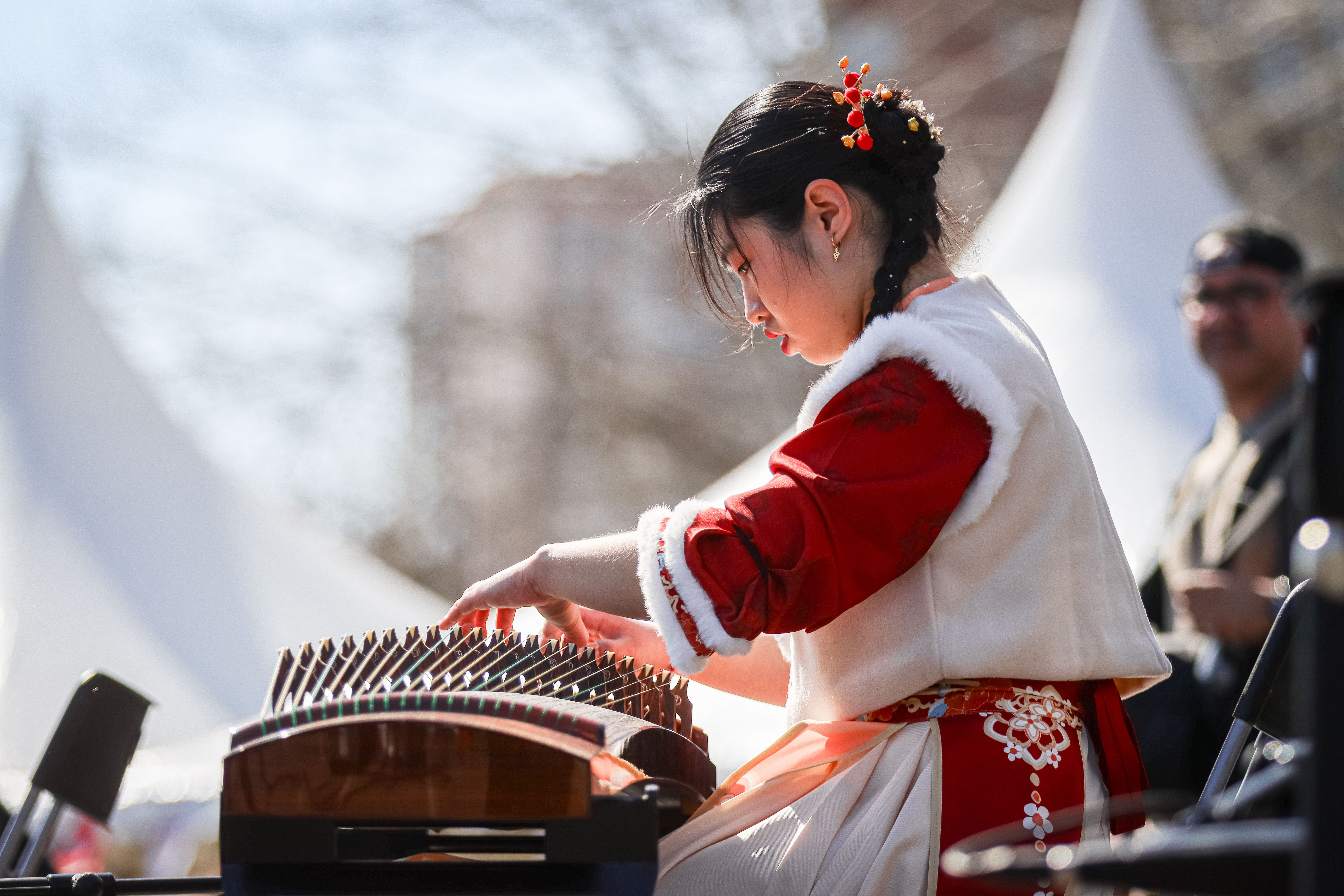 A musician in traditional dress performs on the guzheng at the Madrid Spring Festival