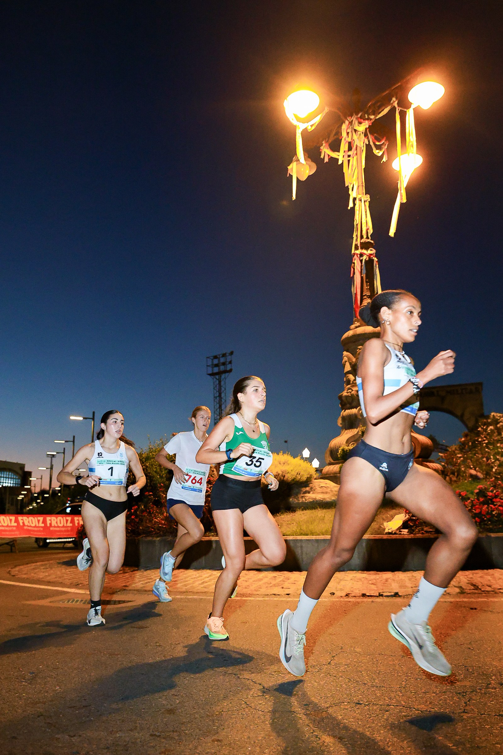 Women race through Marín at night during the Milla de San Miguel