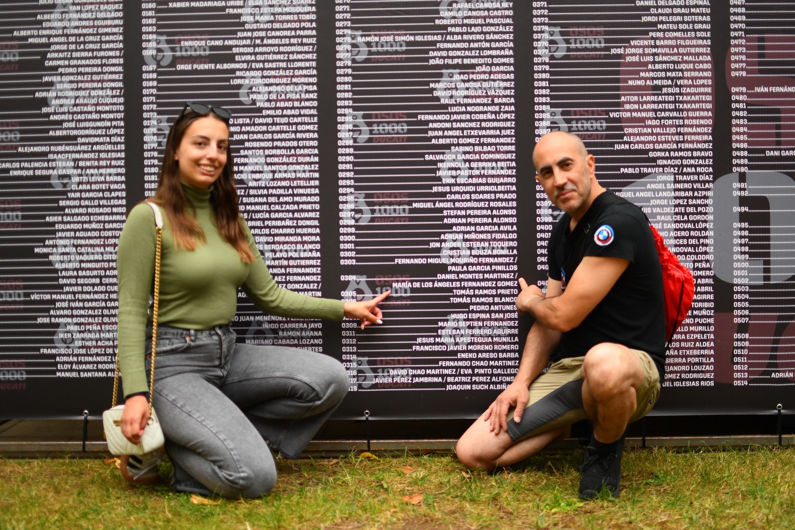 Participants browse a wall listing entrants by bib number ahead of OSOS 1000 in Oviedo