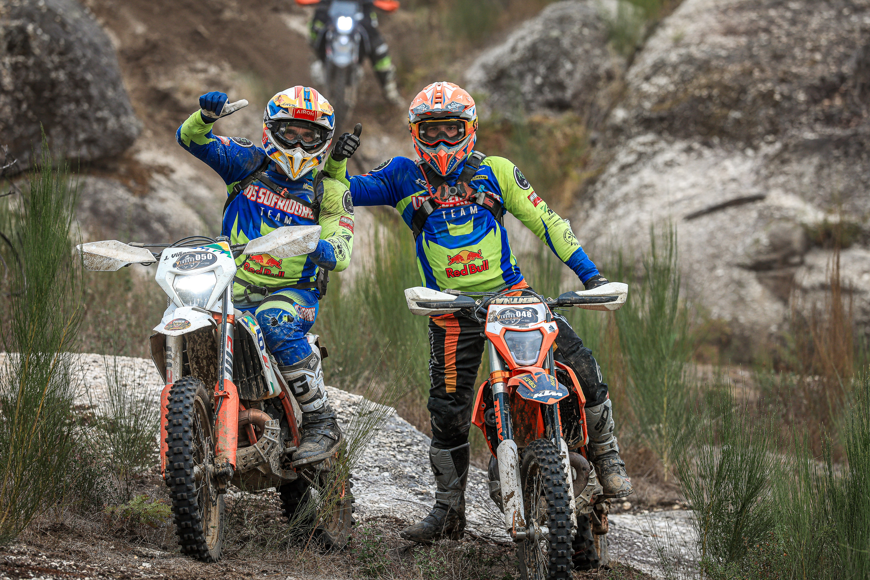 Two off-road motorcyclists pause among the rocky trails near Carregal do Sal