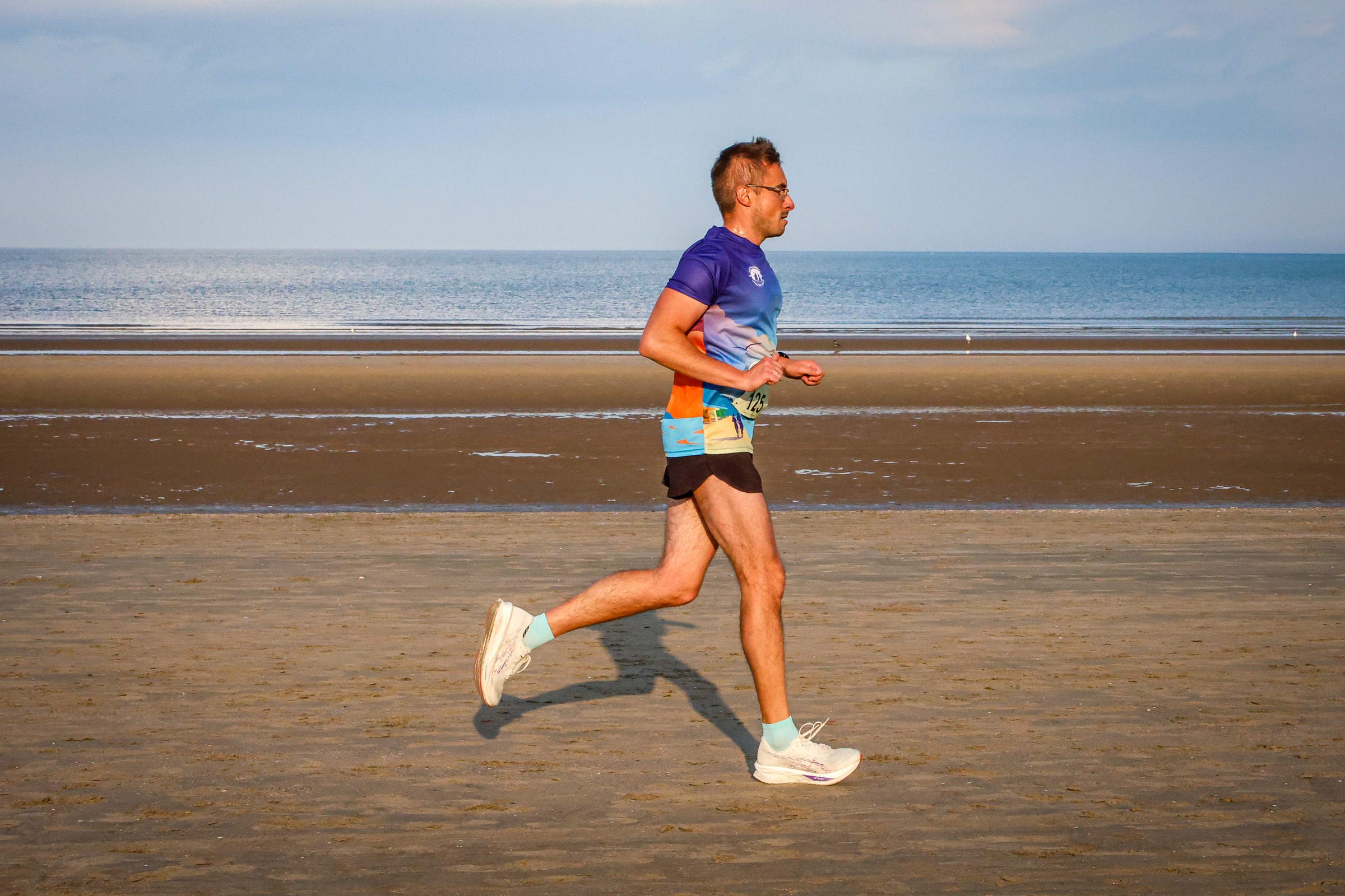 A Portmarnock AC runner strides along the beach beside the Irish Sea
