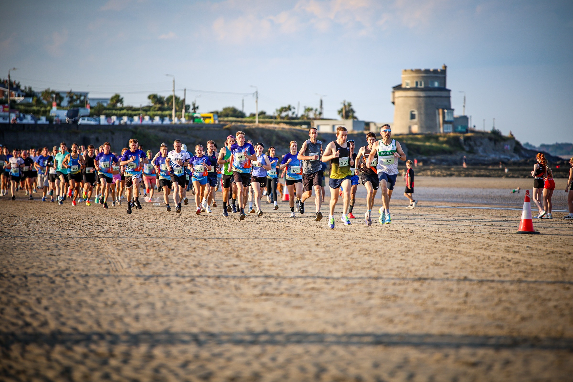 The Portmarnock Beach 5K field runs along the strand with the Martello tower behind
