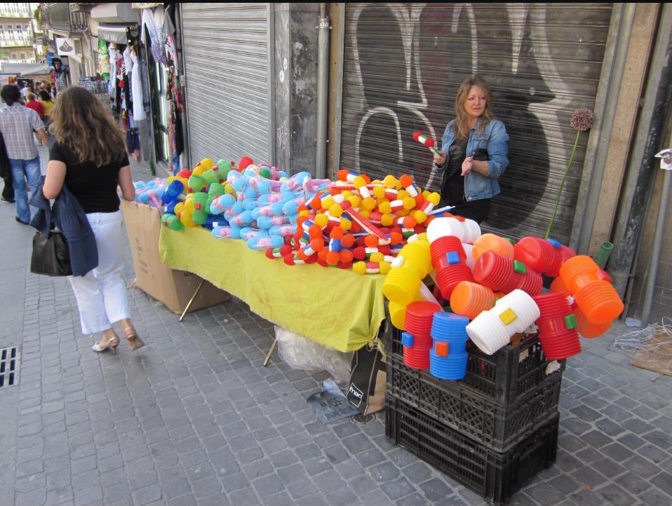 A street vendor sells plastic hammers ahead of São João in Porto