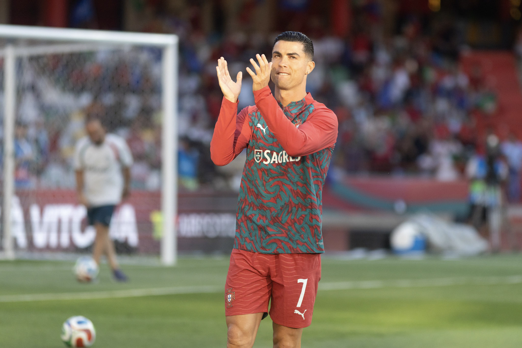 Cristiano Ronaldo applauds supporters while warming up before Portugal's friendly against Nigeria in Leiria