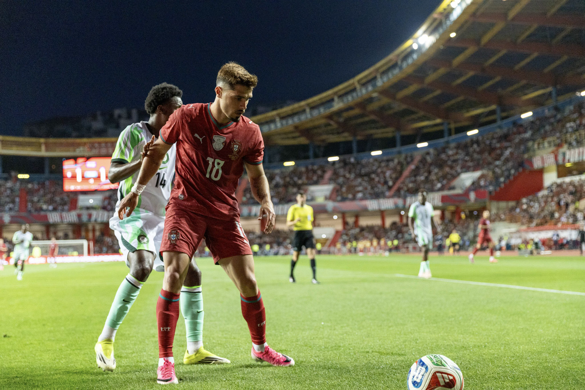Pedro Neto shields the ball from a Nigeria player during Portugal's international friendly in Leiria