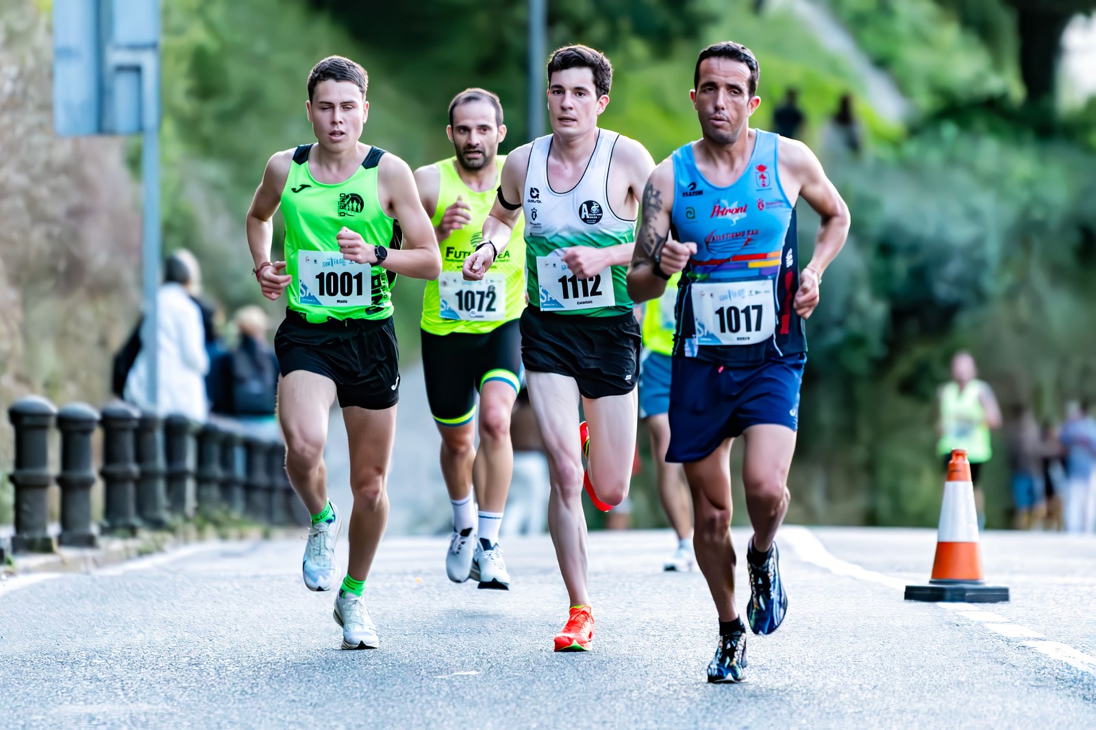 A pack of runners races along a Santiago de Compostela street during the SantYaGo10K