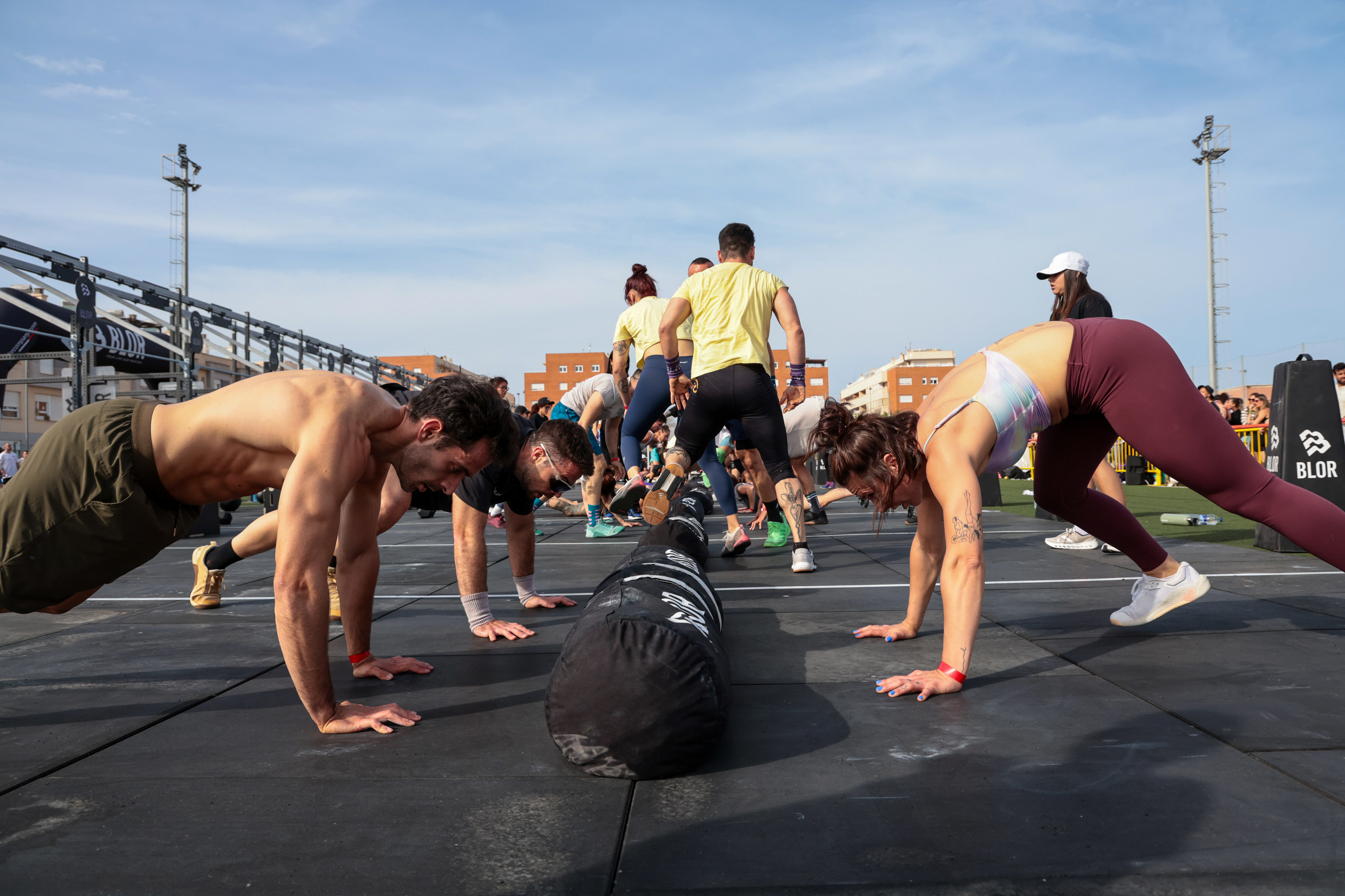 Athletes performing push-ups over a sandbag at The Battle Games