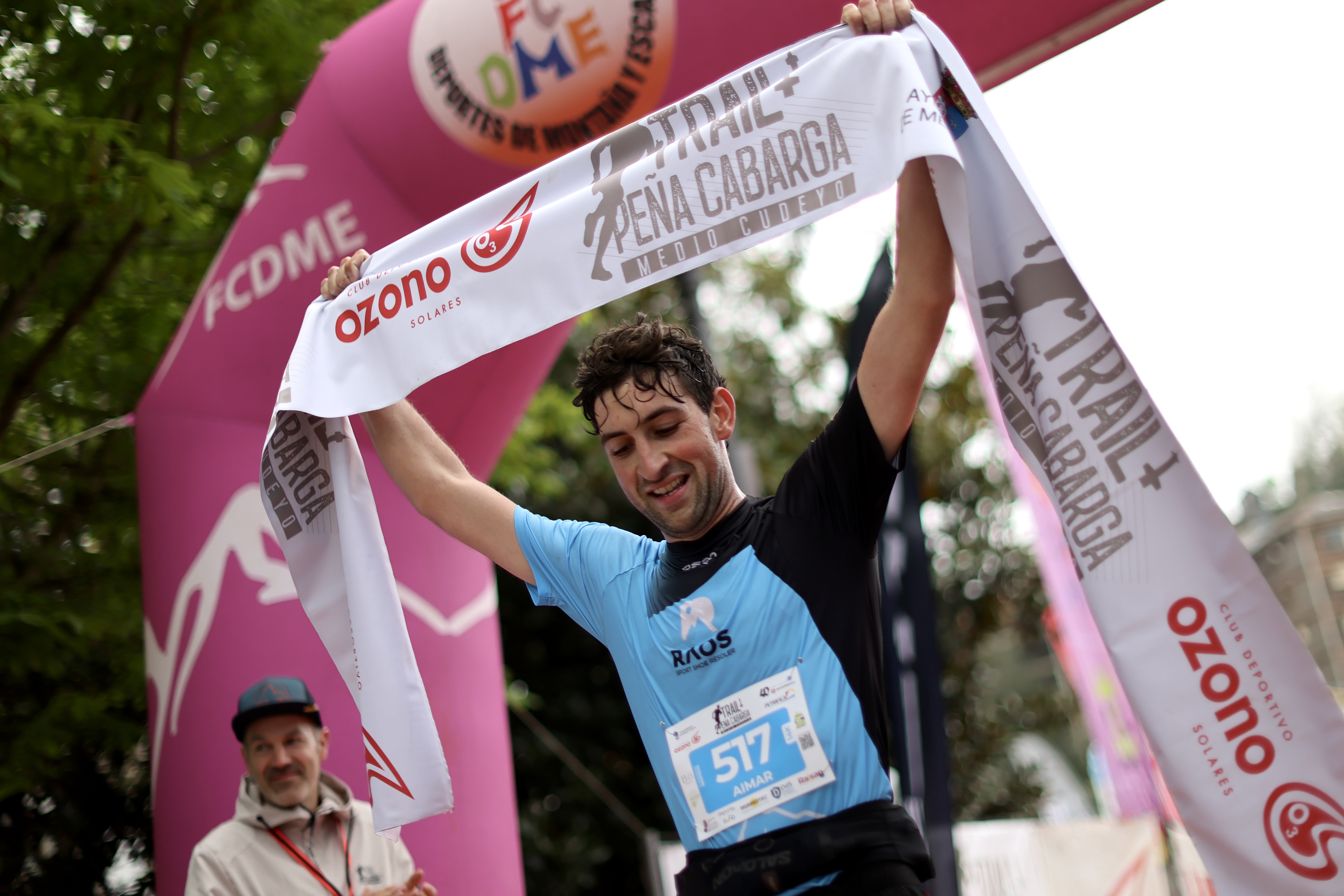 Runner crossing the finish line at Trail Peña Cabarga in Solares