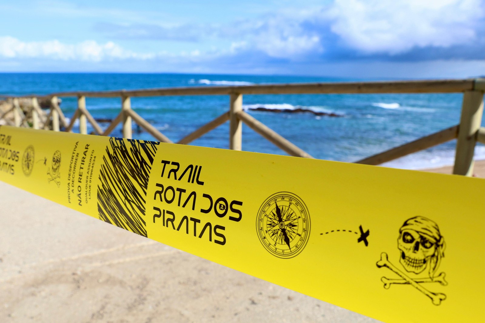 Official Trail Rota dos Piratas course tape overlooking the Ribamar coastline