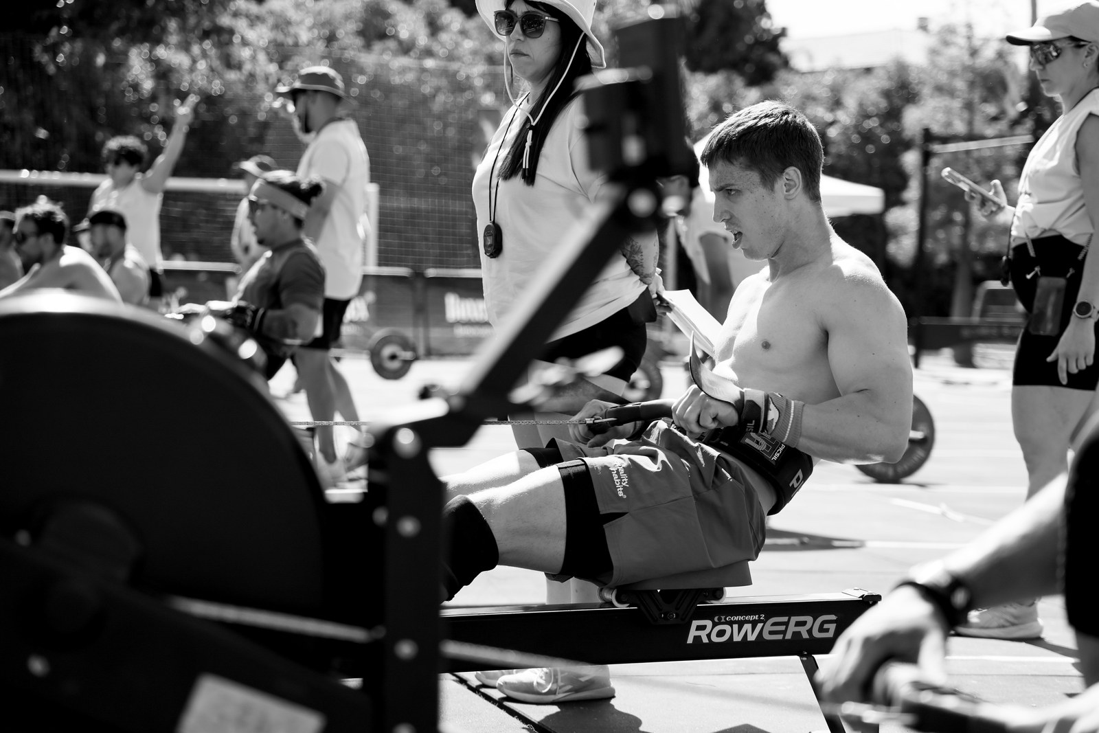 An athlete grimaces mid-effort on a rowing machine during a Valencia Throwdown workout